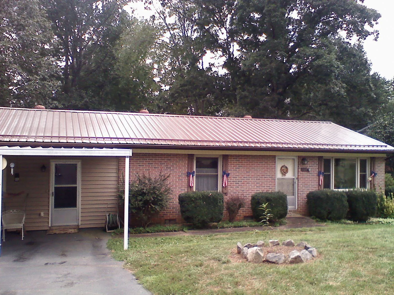 Bronze metal roof and carport on a brick ranch home — Roof Repair work by our crew in Kenilworth
