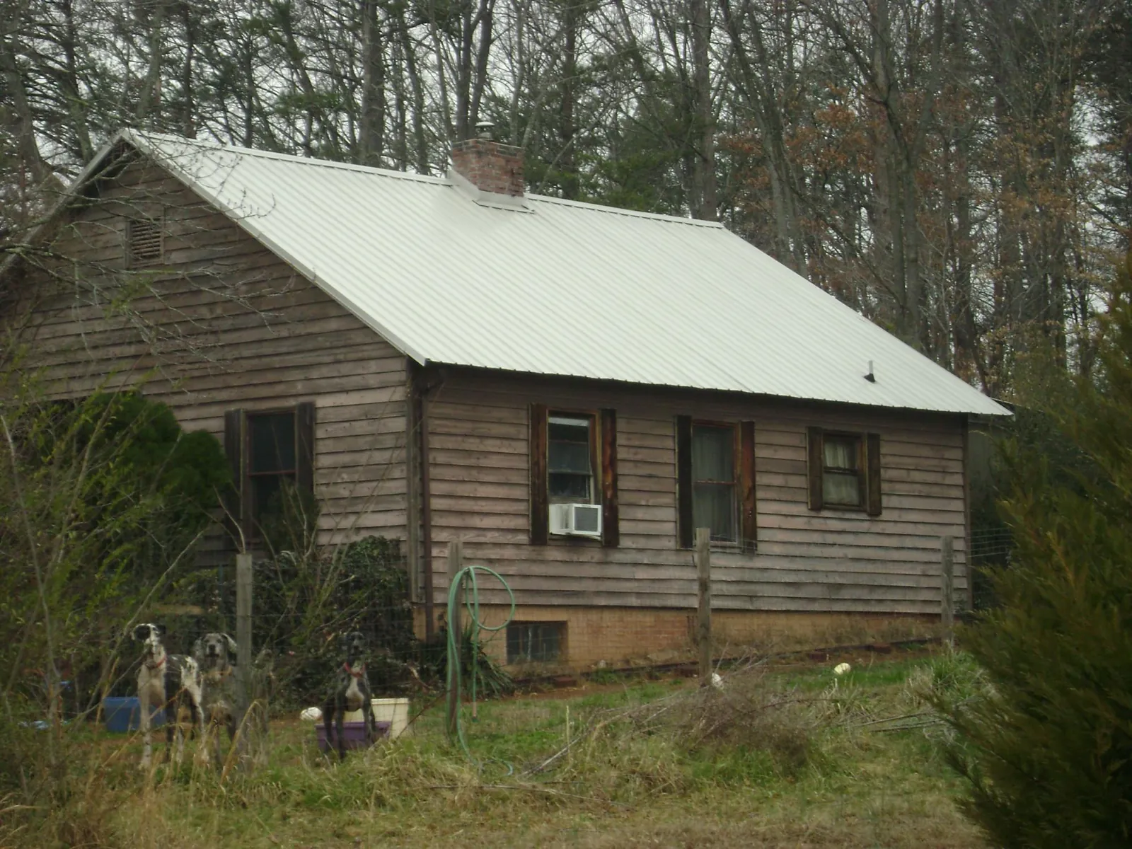 White metal roof on an old wood sided farmhouse, from a Metal Roof Installation job in Kenilworth